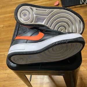 Air Force ones. Orange. Blk. White. Silver Nike sign